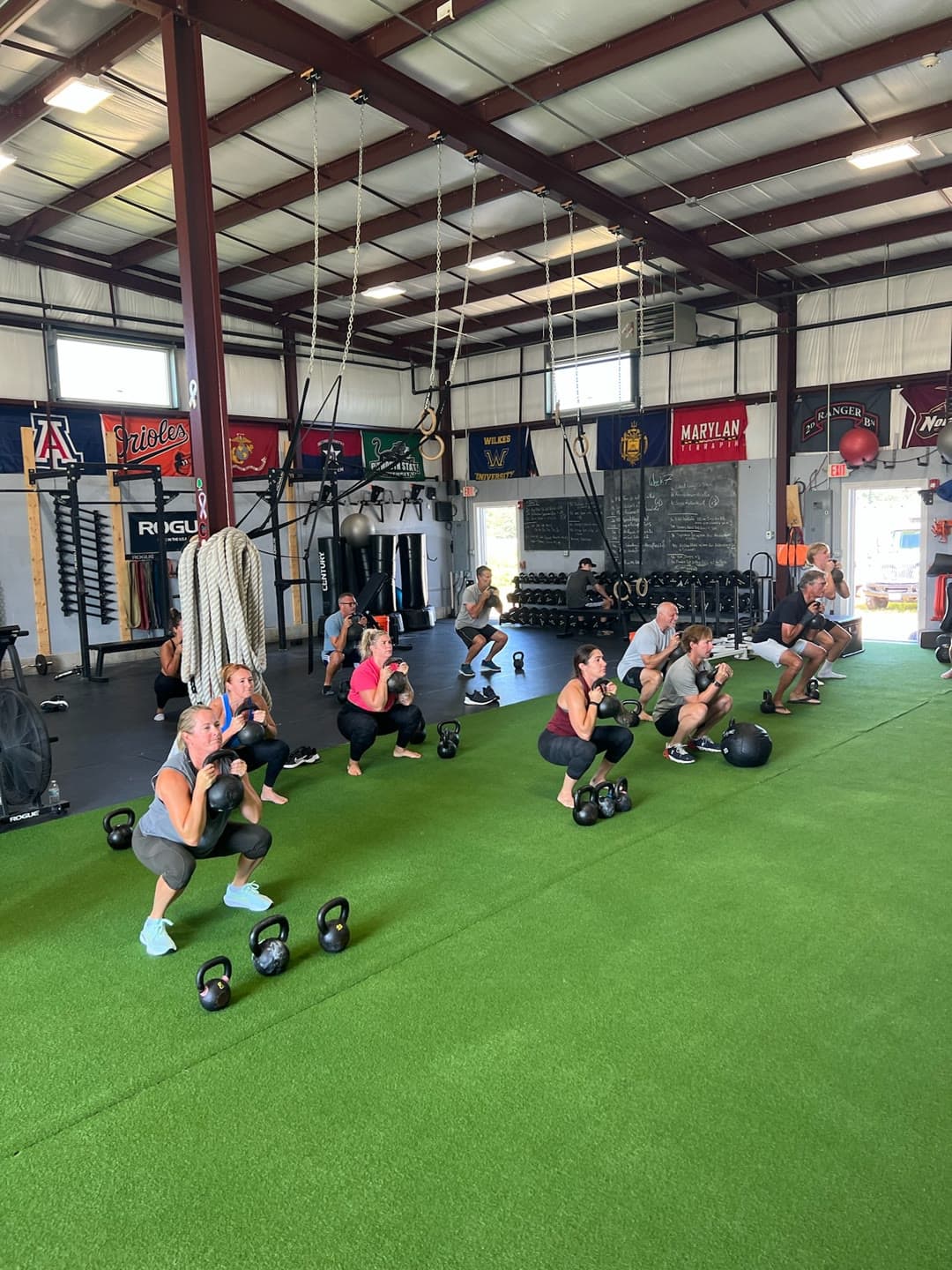 A group class doing kettlebell squats at EPS